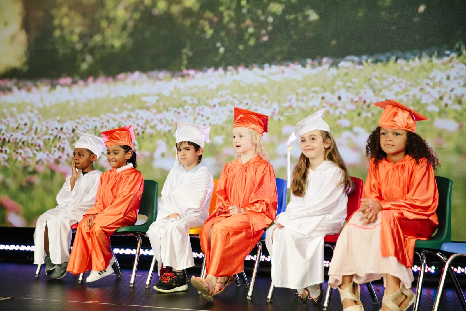 Happy kid graduating from preschool in Alpharetta Georgia, and excitedly planning for a fun summer camp experience in Alpharetta, Georgia, filled with engaging activities and adventures.